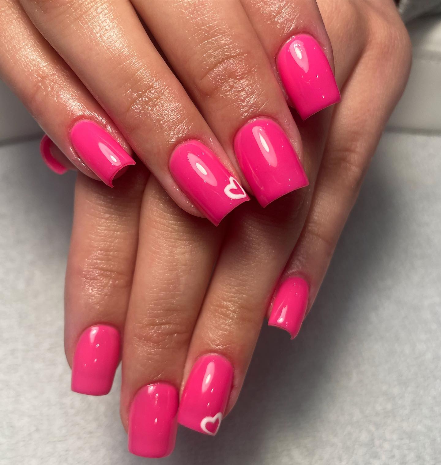 Bright Pink Nails with White Heart Design