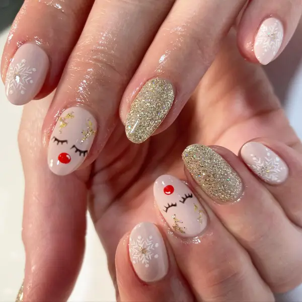 silver glitter nail with a reindeer design