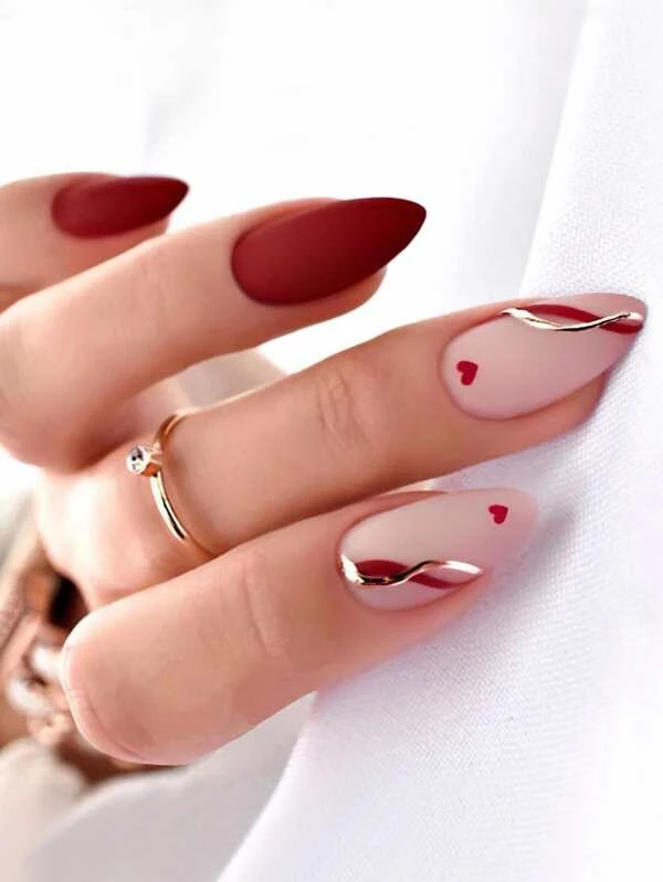 Short red nails with a small red heart design idea