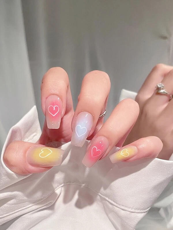 Delightful Multicolor white heart nail design with colorful nail polish look