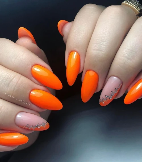 Bright Orange Oval shaped nails with Glitter design