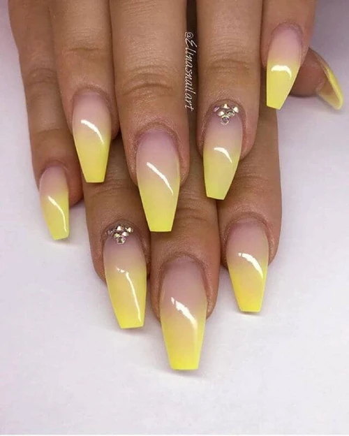 Purple and yellow nail design ombre with gold studs at the top 