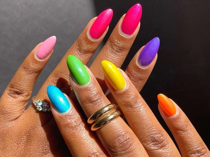 rainbow of neon colors on short oval nails